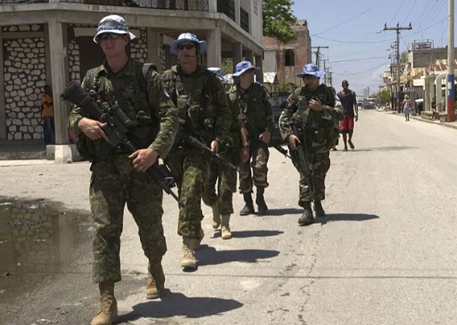 Canadian and Argentinean peacekeepers patrol in Les Gonaïves, Haiti.