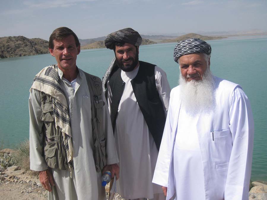 May 2011 — It took a lot of convincing to get Ismael Khan (on the right), Afghan Minister of Energy and Water, to travel to Kandahar to visit one of Canada’s signature projects in Afghanistan — the Dahla Dam. A Tajik warlord from the northwest of the country, he was captured and imprisoned by the Taliban in Kandahar for three and a half years. But he eventually acquiesced. Seen here with the Governor of Shah Wali Khot District at the top of the dam.