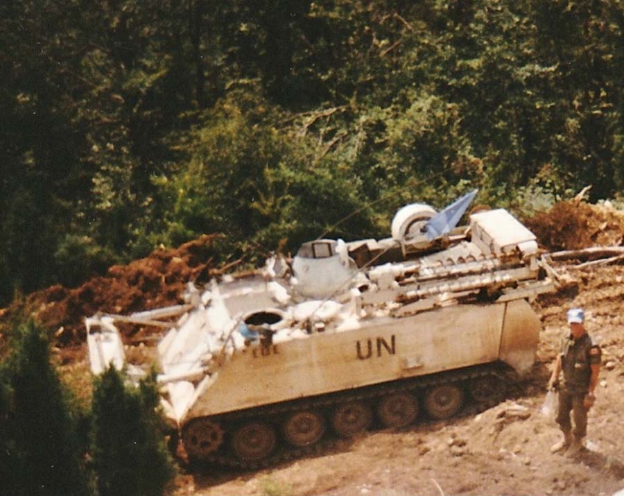 Corporal Greg Purcell stands next to the M113 Dozer Call Sign Echo-13-Echo (E13E) during construction of Observation Post Kilo-Hotel (OP KH). Kiseljak Pocket. August 1994.